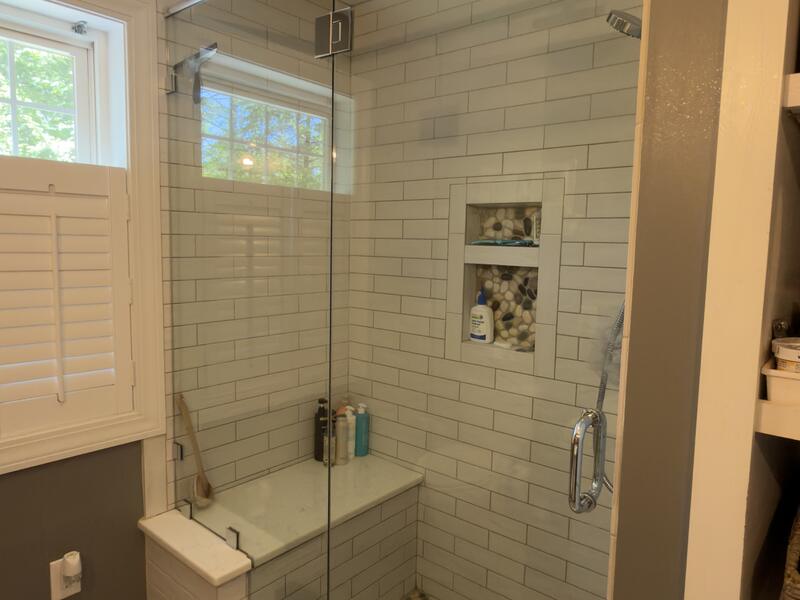 Tiled shower scrubbed by AJ Premium Cleaners, glass and grout spotless after a deep clean