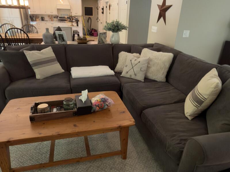 Living room finished by AJ Premium Cleaners, sofa and coffee table with the floor clean
